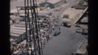Cuba (1962): A Large Crowd Is Gathering Alongside A Road Around Several Shipping