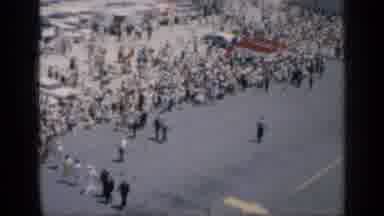Cuba (1962): A Large Crowd Near The Ocean Walking Near The Beach On A Road