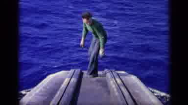 Italy (1962): Man Walking On A Flat Surface Vessel In The Middle Of The Ocean