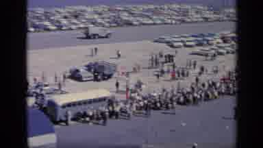 Italy (1962): High Angle A Large Lot Filled With Cars And People