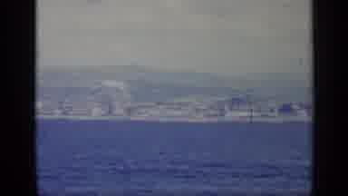 Italy (1962): Floating On The Blue Water Near Sea City With Many Buildings