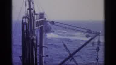 Italy (1962): While In The Ocean A Navy Vessel With A Crane Lifts A Smaller Boat