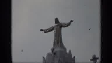 Italy (1962): A Statue Of Jesus With His Arms Spread Wide On Top Of A Cathedral