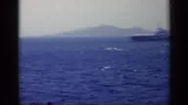 Italy (1962): Ship Floating In Blue Sea With Mountains And Horizon In Background