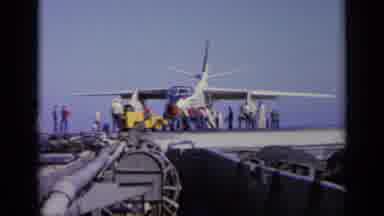Greece (1963): Workers With A Small Crane Moving A War Aircraft On Top On What