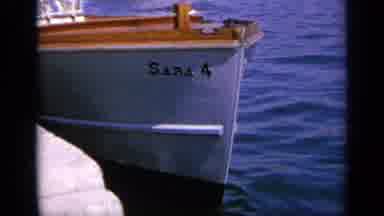 GREECE-1963: Sailor In White Outfit And Cap Ties The Boat Securely To The Dock