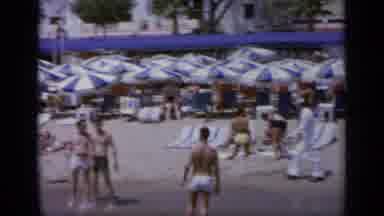 GREECE-1963: Blue And White Umbrellas Lined Up At Beach On A Bright Sunny Day