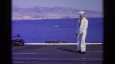 GREECE-1963: Navy Sailor On Port Deck Gesturing Near Sunbathing Women