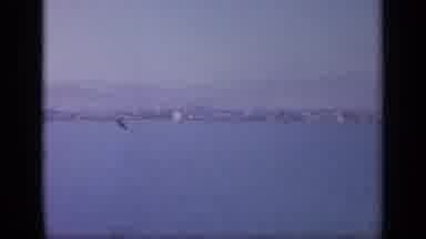 GREECE-1963: Panning View of Coastal City With Mountains and Water