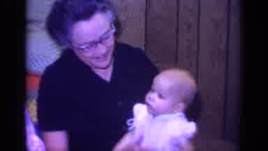 California USA-1968: Woman Holding Baby, Camera Pans to Smiling Man