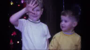 California USA (1968): Two Young Kids Wave At The Home Video Camera On Christmas