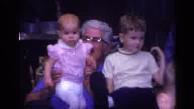 California USA (1968): Toddler Boy Sitting Near Smiling Grandmother Holding Baby