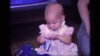 California USA (1968): Baby Trying To Open Food