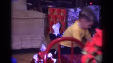 California USA (1968): Kid Opening Presents As People Around Him Watch