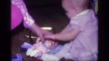 California USA (1968): Baby Unsure Of Toy Doll