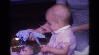 California USA (1968): Lady Picks Up Objects For Tiny Girl To Hold And Inspect