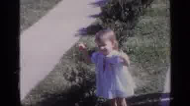 California USA (1968): Little Girl Raises Her Fingers As Mom Watches Then Little