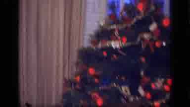 California USA (1968): Woman In Pajamas Steps Away From Presents Under Christmas