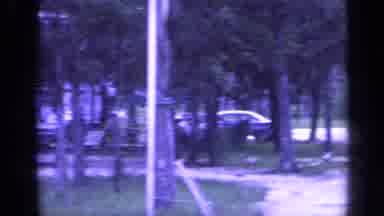 Florida USA (1968): This Is A Park With Someone Walking And Vehicles Parked At