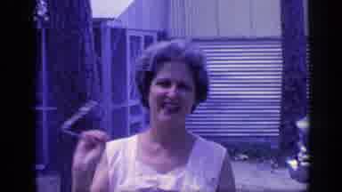 Florida USA (1968): A Woman Wiggles Her Glasses In Her Hand As She Walks Toward