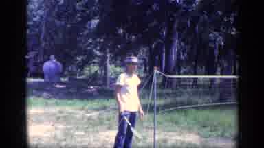Florida USA (1968): Man Stands In Front Of A Badminton Net With A Racquet