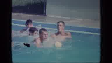 Florida USA (1968): Group Of Young Men Trying To Catch A Ball While Swimming In A