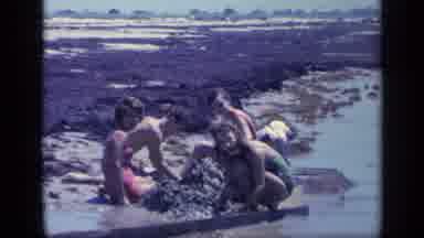 Florida USA (1968): Group Of Two Women And Two Men Kneel And Play In The Mud