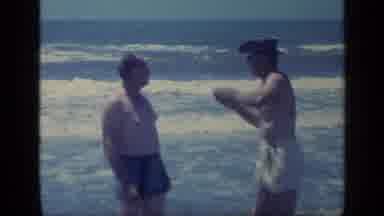 Florida USA (1968): Man Wearing Black Jacket Drives Car On A Bright Sunny Day