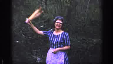 Florida USA (1968): Woman Smiles And Waves Rolling Pin Then Boy Continues Yard