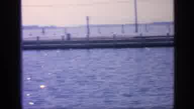 Florida USA (1968): Woman In Green Dress And Sunglasses Overlooking The Water From