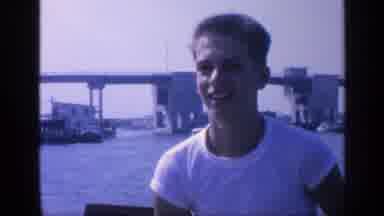 Florida USA (1968): A Young Man Riding A Boat And A Business Building With Many