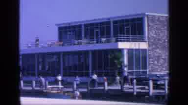 Florida USA (1968): View From Boat Moving Past Dock Building Cars And People With