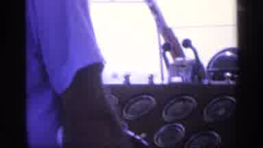 Florida USA (1968): Person Wearing White Shirt Operating Controls Of A Ship While