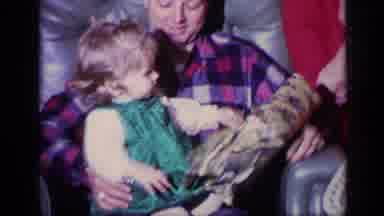 California USA (1969): Child Opening Presents With Family