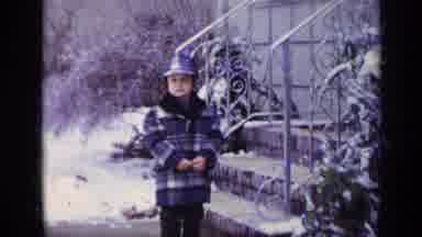 California USA (1969): Child Waiting On The Sidewalk In The Winter