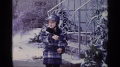 California USA (1969): Young Child In Coat And Hat Gesturing And Standing In Front