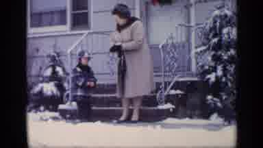 California USA (1969): Mom And Son Out On The Front Porch In The Snow Putting On