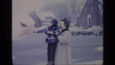 California USA (1969): Woman Holding Up A Small Boy So He Can Pet The Nose Of A