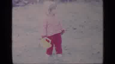 California USA (1969): Little Girl In Pink Pants And A Pink Jacket Stands In Grass