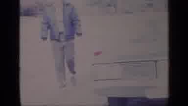 California USA (1969): Middle Aged Man In Jacket Walking Around A Car During The