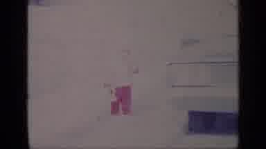 California USA (1969): Small Child Wearing Red Pants Holding Toy Walking On