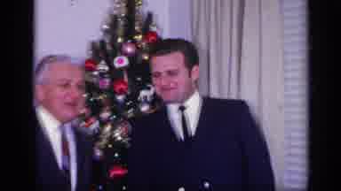 California USA (1969): Two Men In Front Of A Christmas Tree