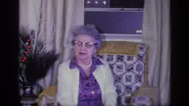 California USA (1969): Elderly Lady Sitting In A Room By The Window About To Speak