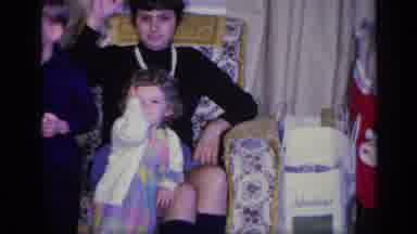 California USA (1969): Children Posing For A Photo While An Adult Is Sitting In An