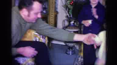 California USA (1969): Man In Green Shirt Shaking Hand Of Girl In Dress