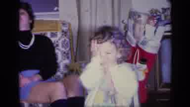 California USA (1969): Girl Covers Face With Hands Then Boy Wipes His Nose And