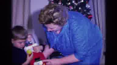 California USA (1969): A Family Christmas With An Old Lady Giving Gifts To A Boy