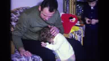 California USA (1969): Man Encourages Little Girl To Look At Camera But She Is Too