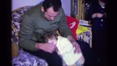 California USA (1969): Dad Sitting On Sofa As Daughter Hugs Him And Kids Open