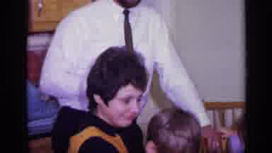 California USA (1969): Man Woman And Children Are At A Table Smiling